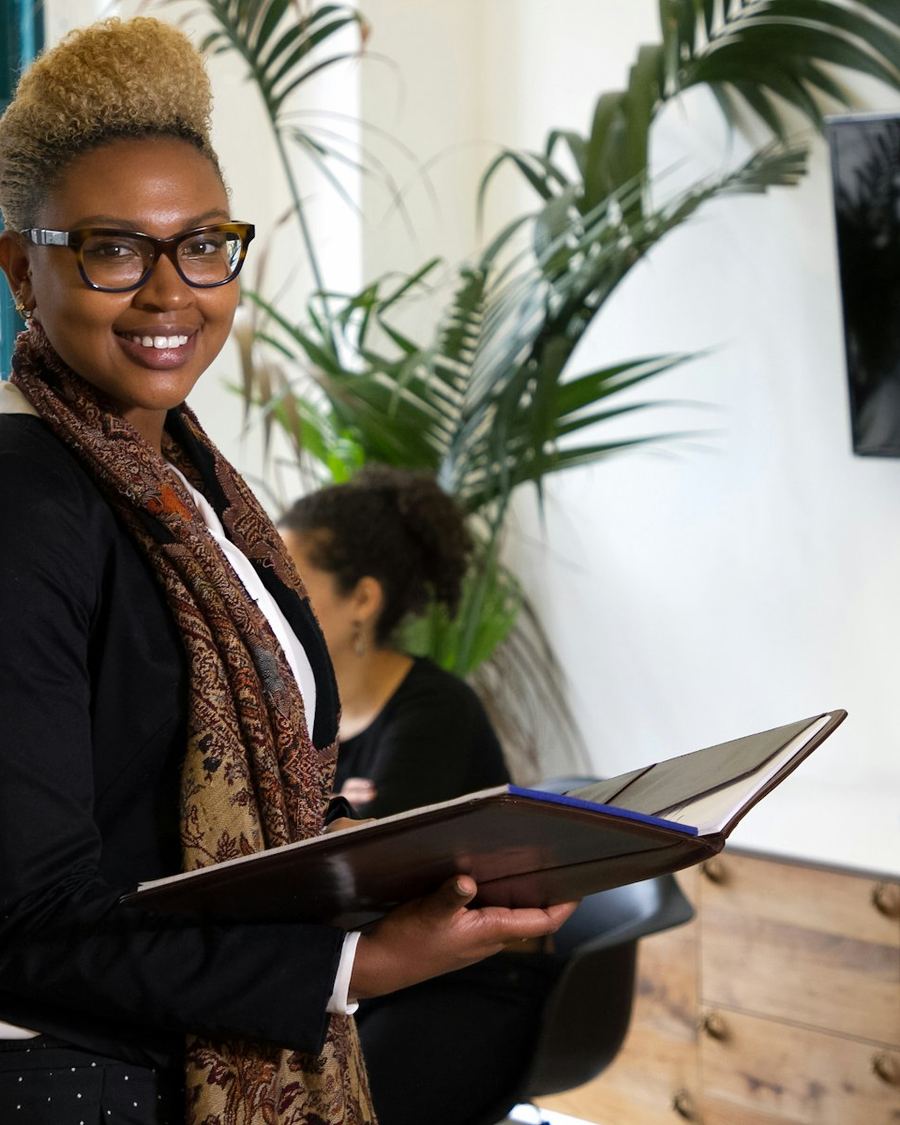 Business owner holding her company documents in her office